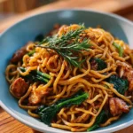 Taiwanese Three Cup Chicken Noodle Stir Fry with colorful vegetables and herbs