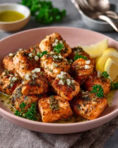 Crispy air fryer salmon bites served with dipping sauce on a plate