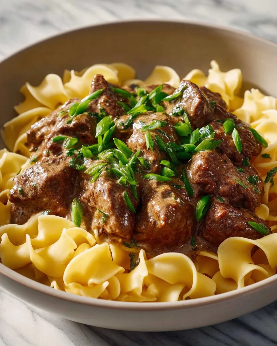 Delicious Beef Stroganoff served with egg noodles and garnished with parsley