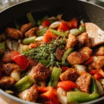 Delicious Black Pepper Chicken garnished with vegetables on a plate