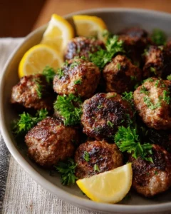 Delicious Greek meatball dish (Keftedes) served with herbs and sauce.