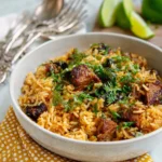 Plate of leftover pulled pork Spanish rice topped with fresh herbs