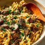 Delicious quick beef stroganoff served on a plate with fresh parsley garnish.