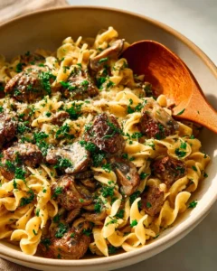 Delicious quick beef stroganoff served on a plate with fresh parsley garnish.