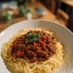 Delicious slow cooker Bolognese sauce served over pasta.