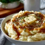 Delicious homemade gravy poured over mashed potatoes.