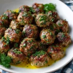 Plate of Greek Meatballs (Keftedes) with herb butter drizzled on top