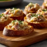 Hot ham and cheese dip served in a bowl with tortilla chips
