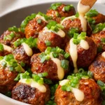 Crock Pot Buffalo Ranch Meatballs served in a white bowl with celery sticks