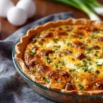 Delicious loaded baked potato quiche topped with cheese and green onions