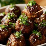 Delicious saucy Asian meatballs garnished with herbs and served in a bowl