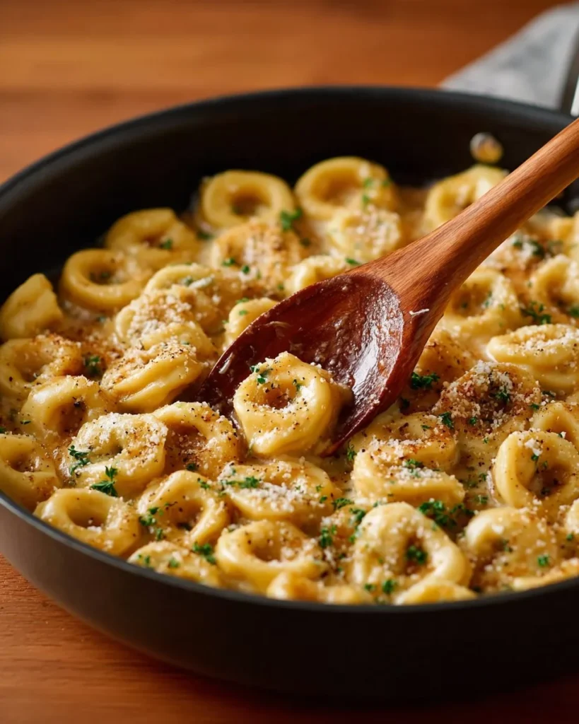 Creamy Tortellini Alfredo served with parsley garnish