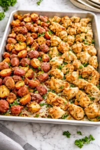 Baked Garlic Parmesan Chicken with seasoned potatoes on a rustic plate