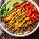 Delicious cheeseburger bowls topped with fresh ingredients and served in a bowl.