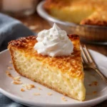 Delicious easy coconut rum pie topped with whipped cream and coconut flakes.
