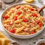 Garlic Baked Feta Salmon Pasta dish with creamy sauce and garnished herbs