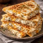 High-protein chicken ranch quesadillas served on a plate garnished with fresh herbs.