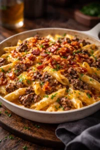Creamy loaded bacon cheeseburger alfredo pasta topped with crispy bacon and cheese