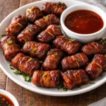 Slow Cooker Bacon Wrapped Lil' Smokies served in a bowl with toothpicks