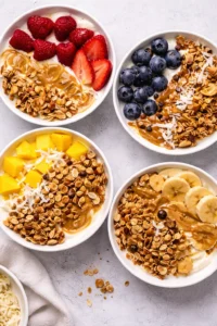 Healthy yogurt granola bowl topped with fresh fruits and nuts