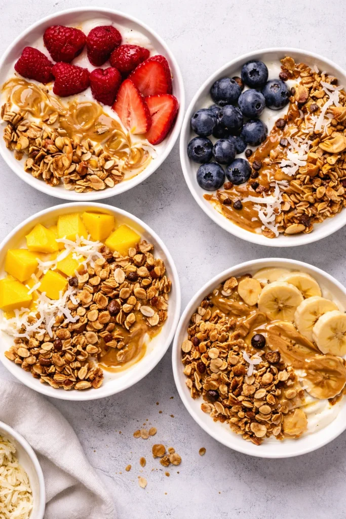Healthy yogurt granola bowl topped with fresh fruits and nuts