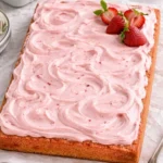 Moist and delicious strawberry sheet cake with fresh strawberries and cream topping.