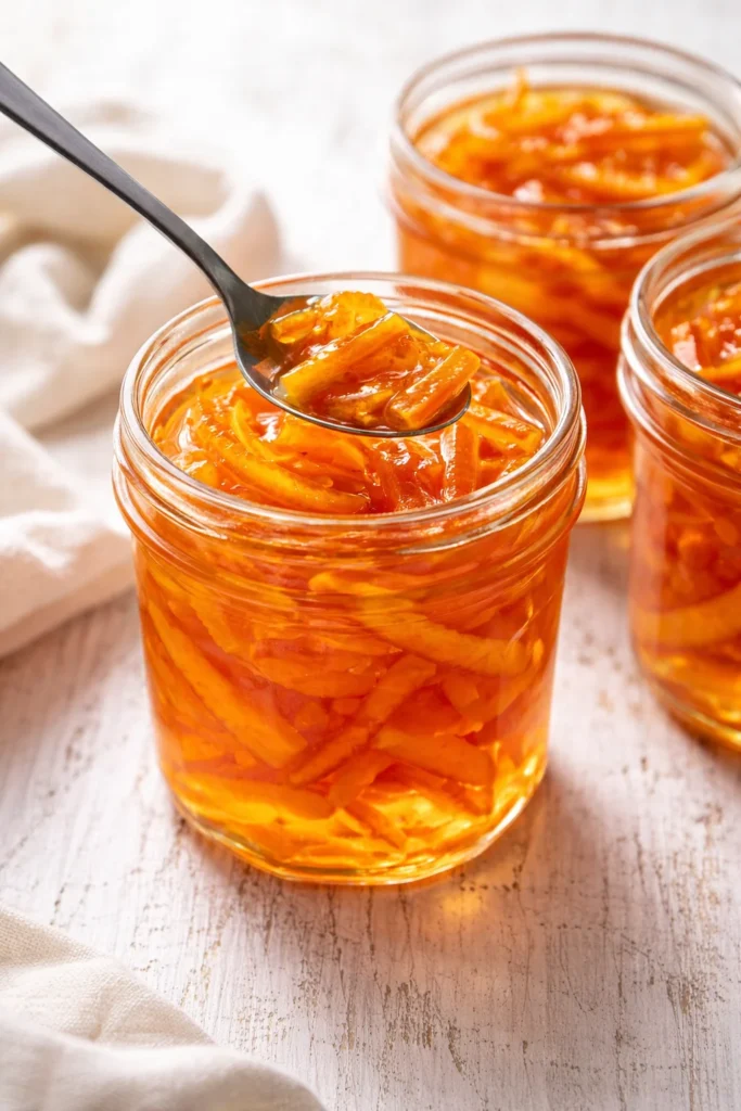Delicious candied orange peel in syrup served on a plate