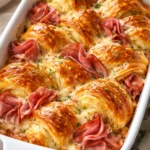Freshly baked croissants on a cooling rack, golden and flaky.