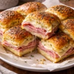 Delicious ham and swiss sliders served on a platter for a party
