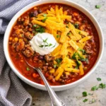 Bowl of easy taco soup topped with cheese and cilantro