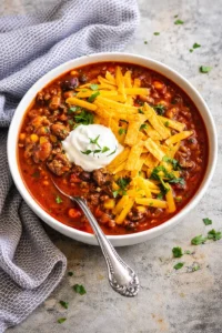 Bowl of easy taco soup topped with cheese and cilantro