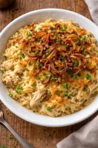 French Onion Chicken Orzo Casserole topped with melted cheese and herbs