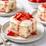 Delicious fresh strawberry cake topped with fresh strawberries and whipped cream
