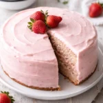Delicious fresh strawberry cake topped with whipped cream and fresh strawberries