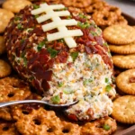 Jalapeño Popper Football Cheese Ball ready for serving at a party