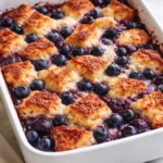 A scrumptious blueberry french toast casserole served with fresh blueberries.