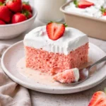 Delicious Strawberry Three Milks Cake soaked in milks and topped with fresh strawberries