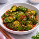 Bowl of Asian Spicy Cucumber Salad with vibrant veggies and dressing