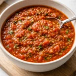Jar of homemade canned tomato salsa with fresh ingredients