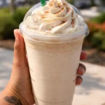 Cinnamon Roll Frappuccino topped with whipped cream and cinnamon dust