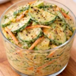 Creamy Asian cucumber salad bowl with fresh vegetables and dressing