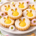 Easter Lemon Linzer cookies decorated with frosting and colorful sprinkles