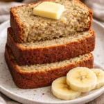 Sliced easy moist banana bread on a wooden cutting board