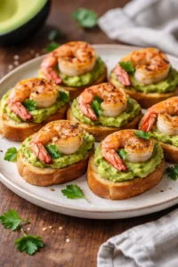 Garlic shrimp crostini topped with creamy avocado on toasted bread
