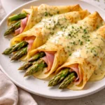 Delicious Ham and Asparagus Crepes served with a side salad