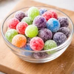 Bowl of colorful Kool-Aid Grapes coated in fruit-flavored powder