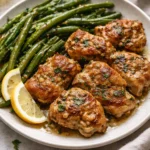 Lemon Garlic Butter Chicken Thighs dish garnished with herbs