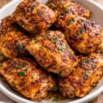 Delicious oven baked chicken thighs served with herbs and spices