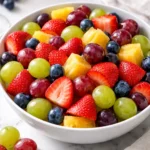 Colorful quick fruit salad featuring fresh berries, melons, and tropical fruits.