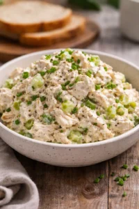 Bowl of fresh, simple chicken salad with vegetables and dressing